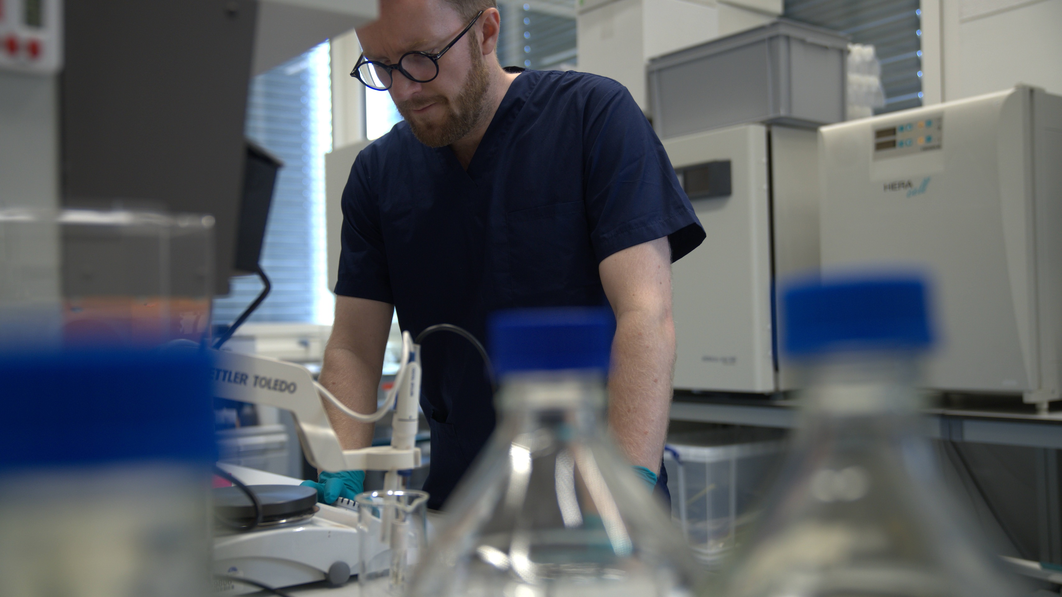 Researcher conducting laboratory work at a cryopreservation workstation